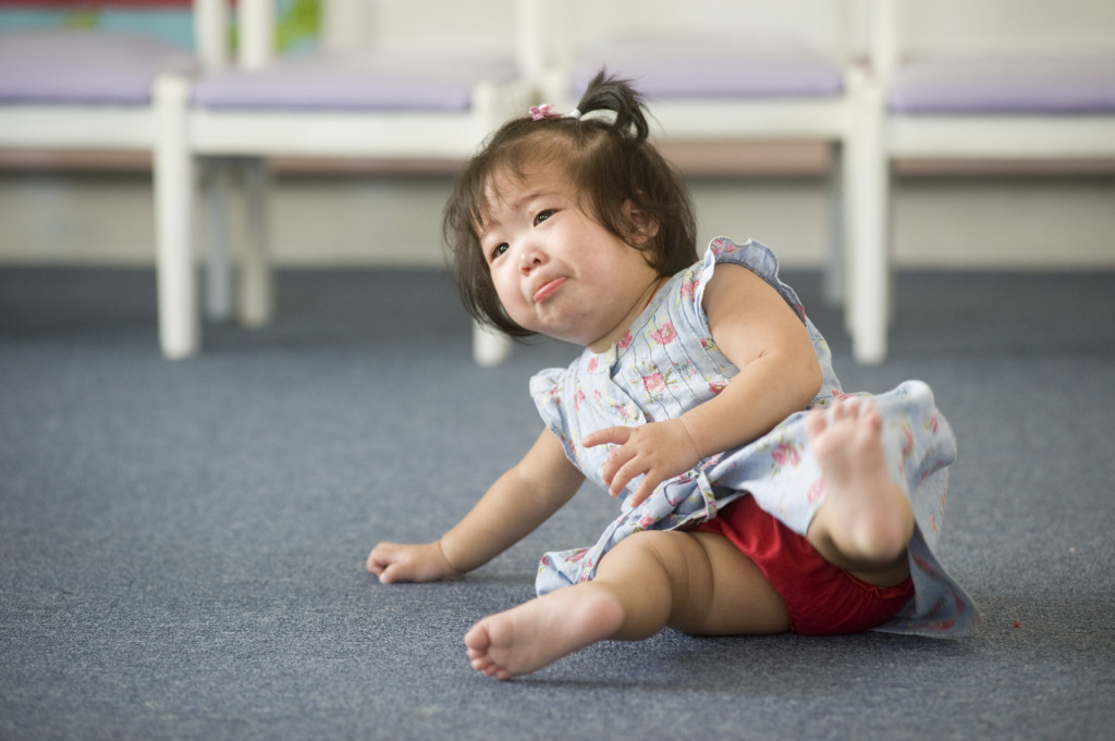 A toddler has fallen down and is just starting to cry